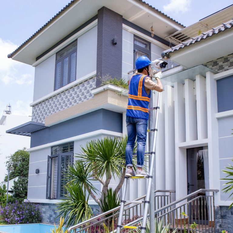 A technician inspecting a security camera during a pre-purchase walk through of a home in Bonita Springs, FL.