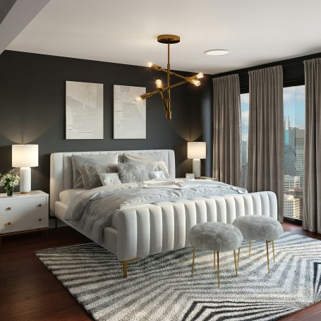 Modern bedroom featuring a gray upholstered bed, stylish lighting, and large windows in Naples, FL.