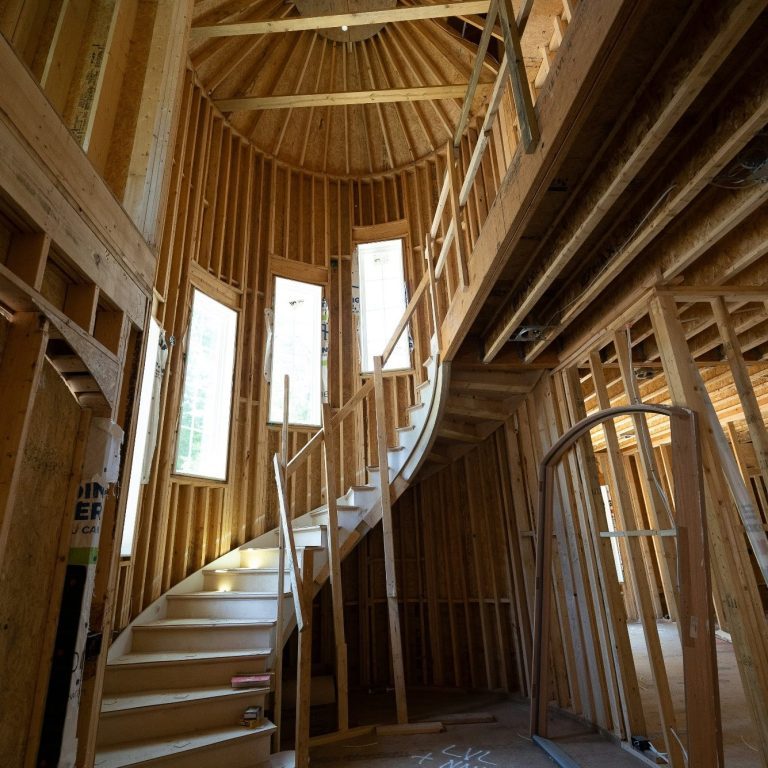 A framed out, spiral, staircase being built inside a North Naples home.