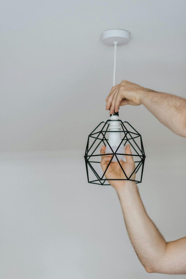 Handyman installing a modern light fixture in Marco Island.