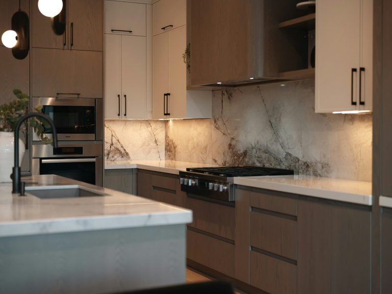 Modern kitchen with marble countertops, sleek cabinetry, and stylish lighting fixtures in Bonita Springs, FL.