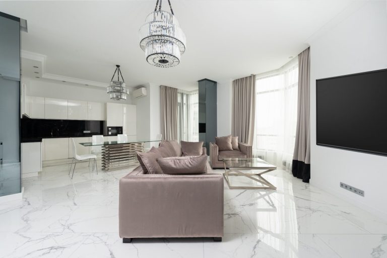 Modern living room with grey sofas, marble floor, and minimalist decor in Marco Island.